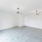 Spacious empty room with modern light fixtures.