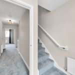 Modern hallway and staircase with blue carpet