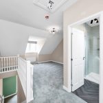 Spacious loft with shower cubicle and window.