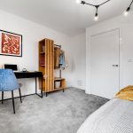 Modern bedroom with desk and wardrobe