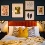 Cosy bedroom with pillows and modern art decor.