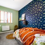 Dinosaur-themed children's bedroom with colourful decor.