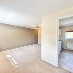 Spacious living room and kitchen area in home.