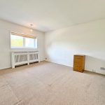 Spacious empty room with chest of drawers