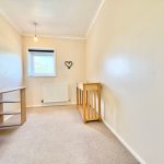 Small room with desk and window.