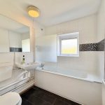 Modern white bathroom with sink and mirror