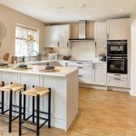 Modern kitchen with breakfast bar and stools.