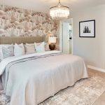 Elegant bedroom with king-size bed and chandelier.
