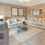 Modern living room with beige sofas and decor.