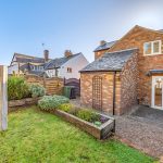 Back garden and brick cottage view.