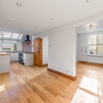 Bright kitchen with wooden floors and modern appliances.