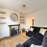 Modern living room with fireplace and black sofa