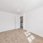 Empty room with carpet and open door