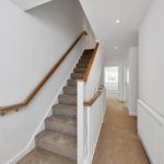 Modern home staircase with wooden railing