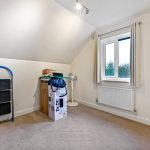 Empty room with boxes, ladder, and window.