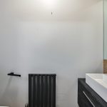 Modern bathroom with white walls and black accents