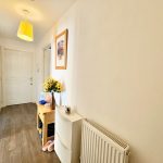 Bright hallway with wooden table and sunflowers