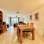Spacious dining area with wooden furniture and decor.