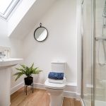 Modern bathroom with skylight and shower.