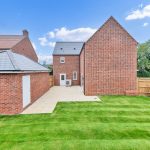 Modern brick house with garden and patio area.
