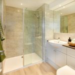 Modern bathroom with walk-in shower and sink.