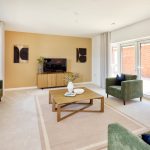 Modern living room with green sofas and wooden table