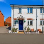 White house with blue doors, sunny day