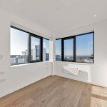 Modern empty room with city view windows