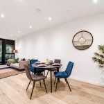 Modern living room with dining area and balcony view.