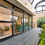 Modern terrace with glass doors and plants.