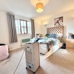 Modern bedroom with double bed and windows