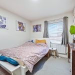 Cosy bedroom with double bed and modern decor.