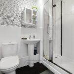 Modern bathroom with shower, toilet, and sink