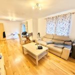Spacious living room with wooden flooring.