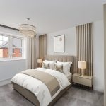 Modern bedroom with neutral decor and stylish lighting.