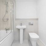 Modern bathroom with shower and tiled walls