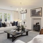 Modern living room with white sofa and fireplace.