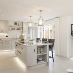 Modern kitchen with island and pendant lights.