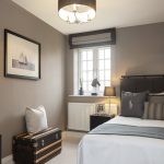 Cosy bedroom with single bed and framed nautical picture.