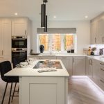 Modern kitchen with island and stylish cabinets.