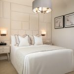 Modern bedroom with elegant decor and soft lighting.