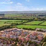 Aerial view of countryside village and green fields