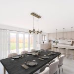 Modern open-plan kitchen and dining area with garden view.