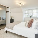 Modern bedroom with mirrored wardrobe and cosy decor