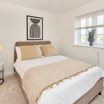 Modern bedroom with artwork and plants.