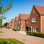 Newly built brick houses on a sunny street.