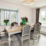 Elegant dining room with wooden table and chairs.