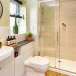 Modern bathroom with shower, sink, and toilet.