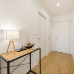 Bright hallway with lamp and modern decor.