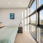 Modern bedroom with large window and minimalist design